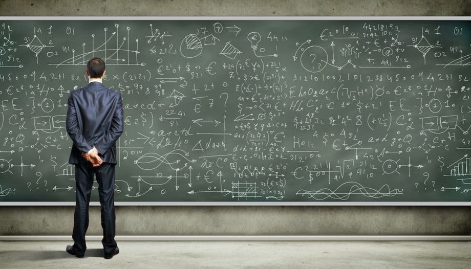 Business person standing against the blackboard